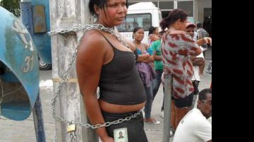 Imagem Em protesto, mulher se acorrenta em frente à hospital